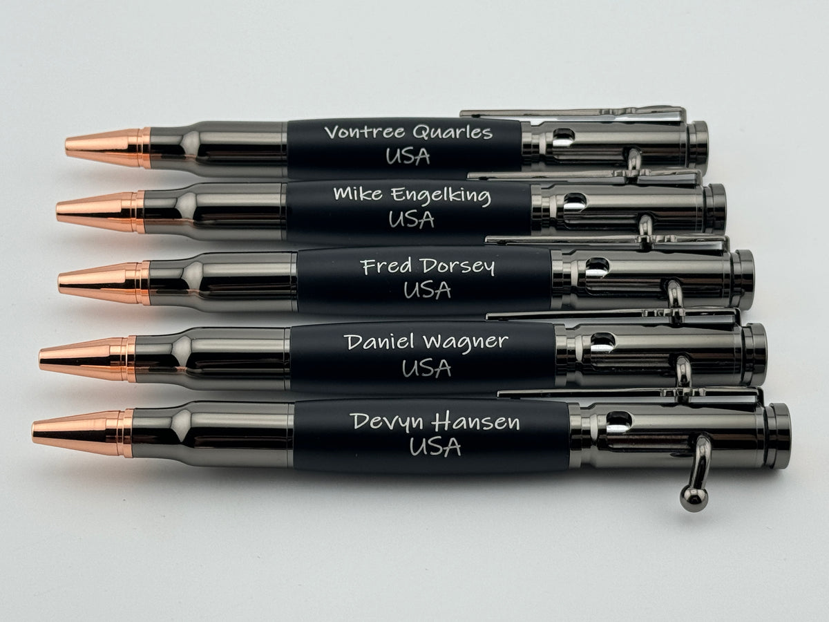 Four black pen sets with individual engraved names in presentation boxes.
