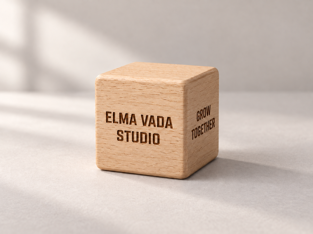 Wooden desk cube engraved with Elma Vada Studio and Grow Together.