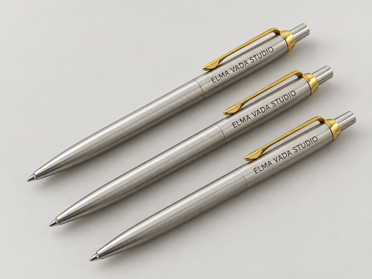 Three silver-tone pens with gold-tone clips and Elma Vada Studio engraving.