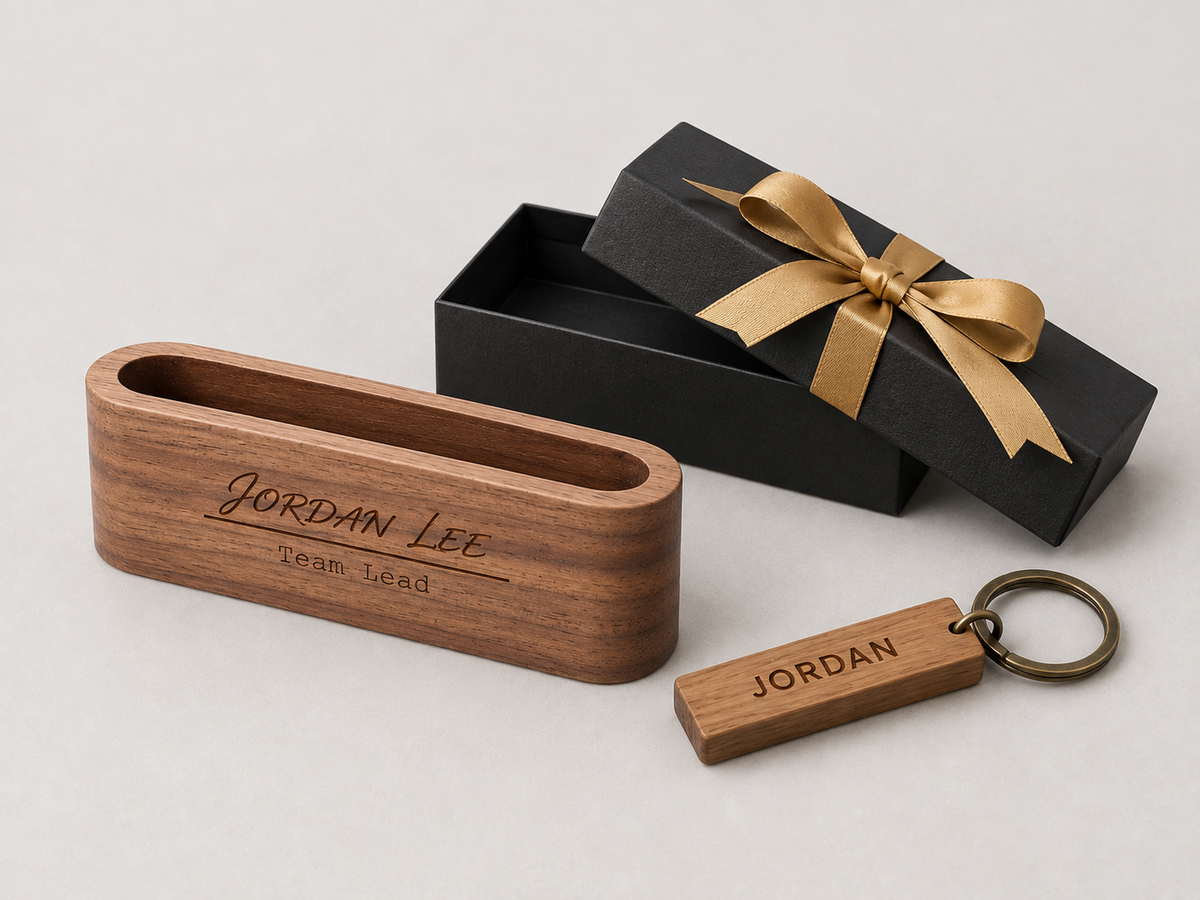 Wooden desk holder engraved Team Lead with a personalized keychain beside a black gift box.