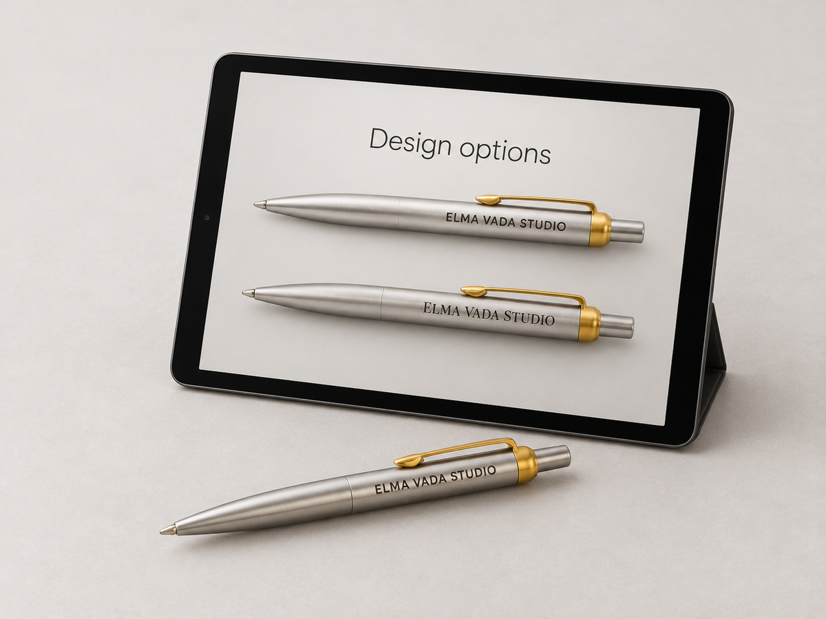 Tablet showing two lettering options on silver pens beside a matching engraved sample pen.