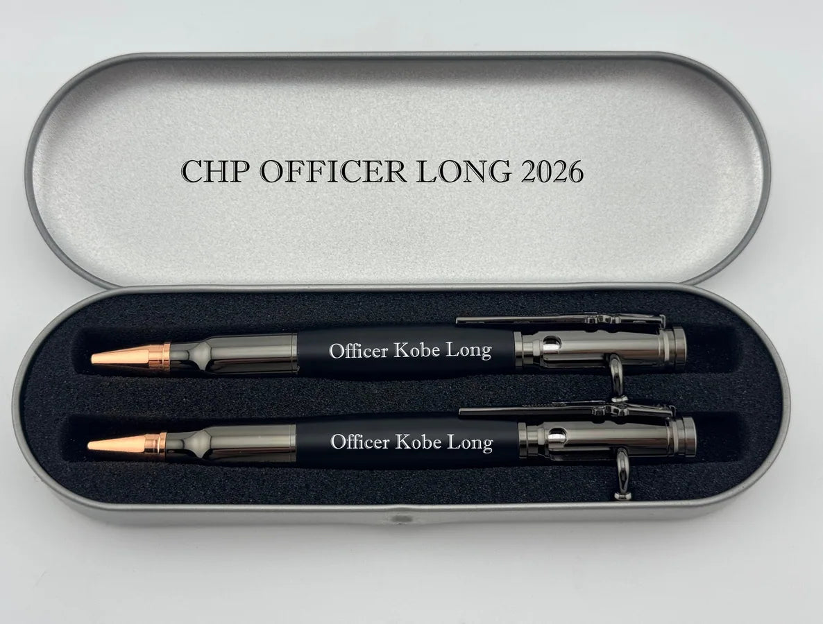 Two black engraved bullet-style pens displayed in an open silver presentation case.